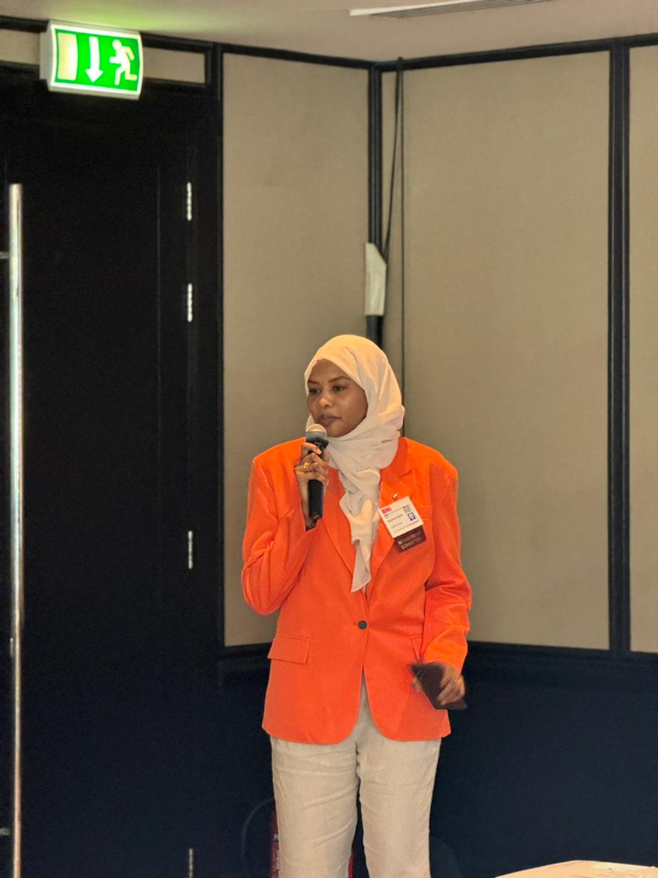 Tasabeeh Adam speaking at a professional conference